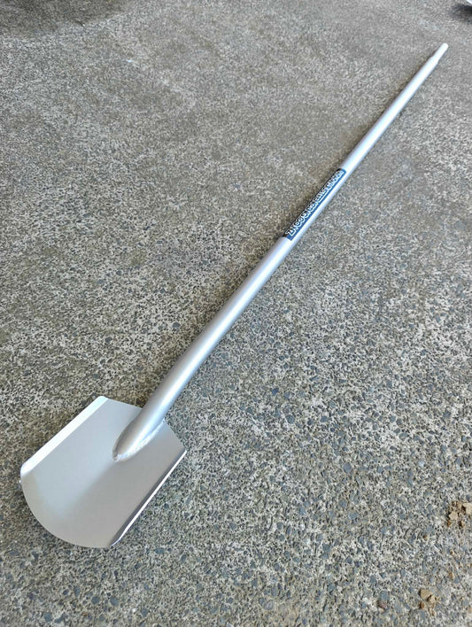 Metal spade on a concrete surface